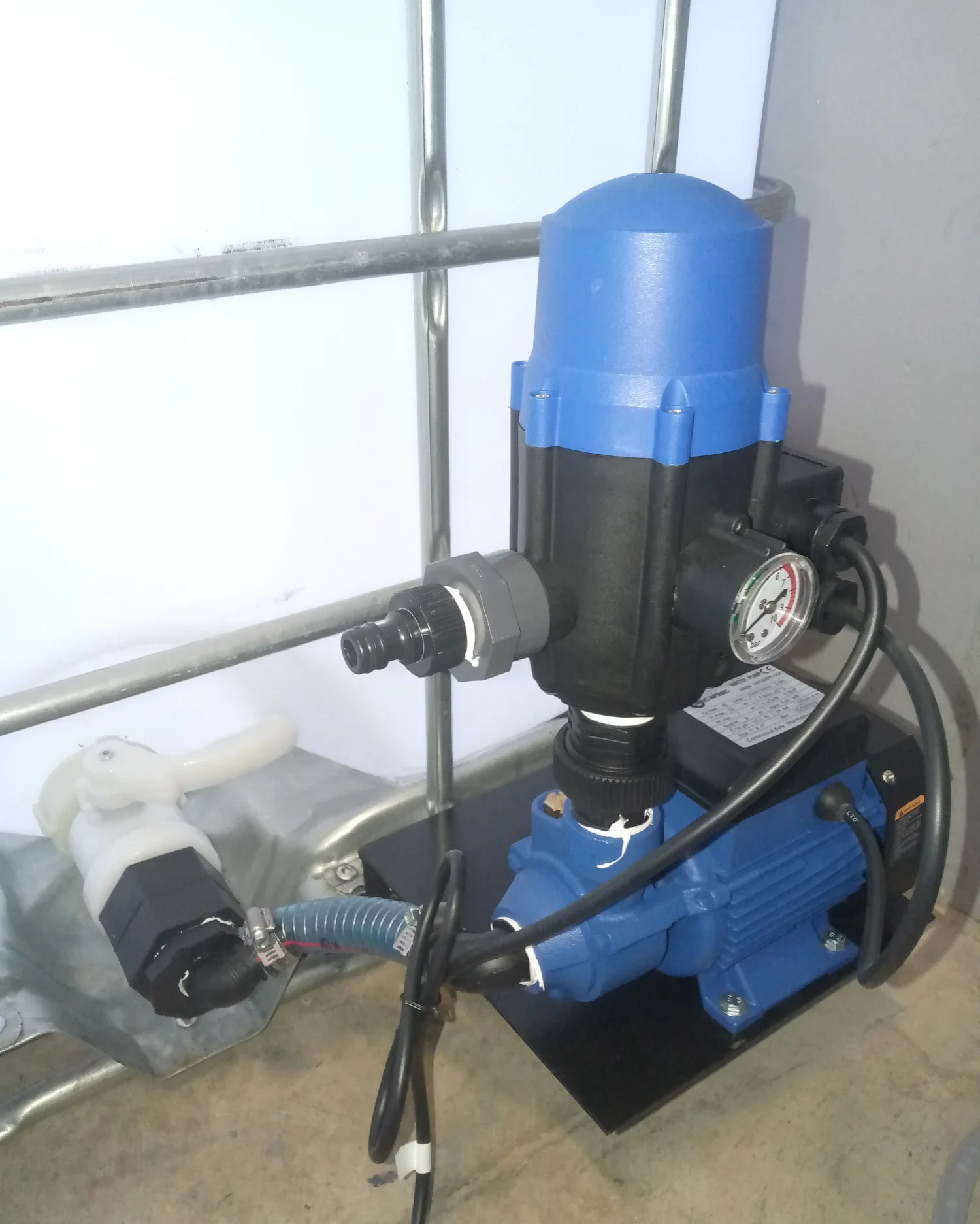 Industrial water pump system installed in a utility room.